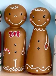 several wooden dolls are lined up on a shelf