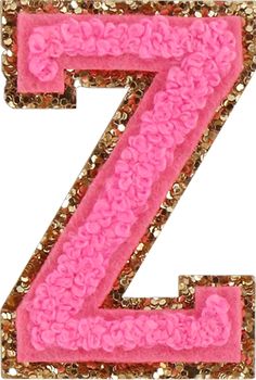 the letter z is made out of pink and gold sequinized fabric with flowers