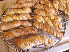 several croissants are cooling on a wire rack