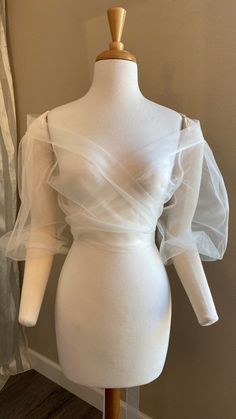 a mannequin with sheer white fabric on it