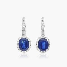 14K White Gold Halo Sapphire and Diamond Petite Drop Earrings. These earrings are fit for a queen. The bold blues of sapphire are surrounded by sparkling diamonds in a perfect halo setting. These drop earrings are set in bright white gold to give a look that is as stylish as it is regal. Sapphire And Diamond Earrings, Halo Setting, Gold Halo, Sparkle Diamonds, Gemstone Earrings, Bright White, Tiara, Diamond Earrings, Halo