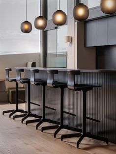 a row of bar stools sitting next to a counter