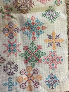 a cross stitch pattern on a piece of cloth