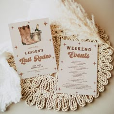 the wedding stationery is laid out on top of a doily with white and gold decorations