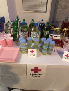 the table is covered with bottled water and plastic cups for medical care workers to use