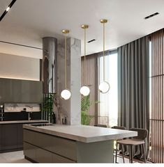 a modern kitchen with marble counter tops and pendant lights