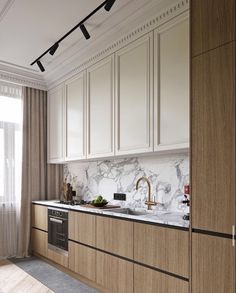 a kitchen with marble counter tops and wooden cabinets