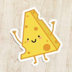 a piece of cheese sticker sitting on top of a wooden table