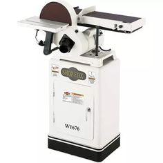 a table sawing machine sitting on top of a white box