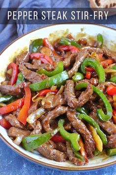 beef and peppers stir fry in a white bowl