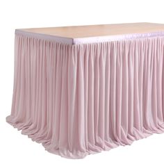 a pink table with pleated skirt on top