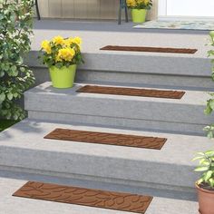 the steps are decorated with flower pots and potted plants on each step, along with two planters filled with yellow flowers