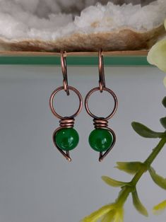 Green Onyx Earrings. Wire Wrapped copper Earrings. Green Onyx is an alternative birthstone for May. 8mm Green onyx bead wrapped in oxidised copper - these are nice and lightweight. Copper will continue to darken, but can polished to show the highlights. Picture shows oxidised copper. Green Onyx carries with it the primary properties of all forms of Onyx which are known for strength, willpower and discipline. The green varieties stimulate these traits directly from the heart. It's able to soothe Copper Wire Earrings, Oxidised Copper, Diy Earring, Earrings Wire, Gem Earrings, Wrapped Earrings, Crystal Therapy, Earring Designs, Birthstone Earrings