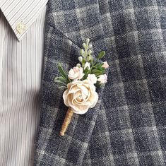 a boutonniere with flowers on it is being worn by a man in a suit