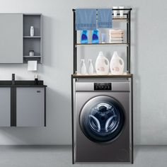 a washer sitting next to a dryer in a room with shelves on the wall