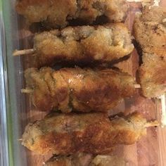 chicken skewers sitting on top of a wooden cutting board