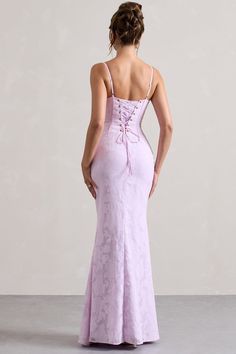 the back of a woman in a lila colored evening gown with spaghetti straps and lace detailing