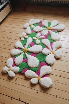 a rug with white and pink flowers on it