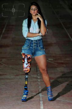 a woman in short shorts and knee braces posing for the camera with her hand on her hip