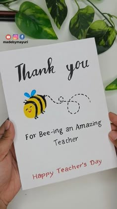 a person holding up a card with a bee on it that says, thank you for being an amazing teacher