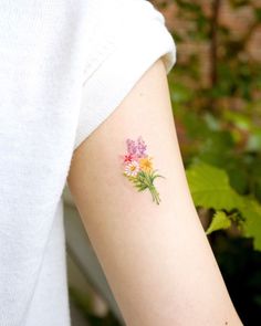 a woman with a flower tattoo on her arm