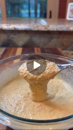 a mixing bowl with batter in it and a wooden spoon sticking out of the top