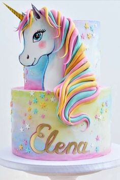 a cake decorated with an unicorn on top of a white pedestal and the name gena written on it