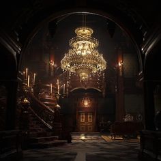 a large chandelier hanging from the ceiling in a dark room with stairs leading up to it