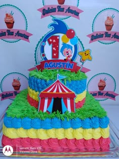 a birthday cake that is shaped like a circus tent and has the number one on it