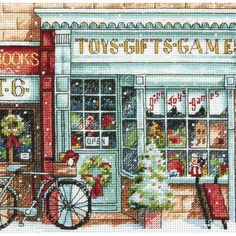 a cross stitch christmas card with toys and games in front of a storefront window