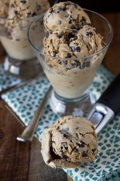 three scoops of ice cream with chocolate chip cookies in them on a green and white napkin