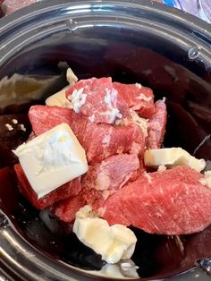 raw meat and cheese in a slow cooker