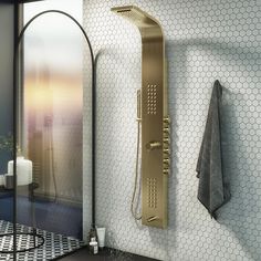 a bathroom with a shower head and hand held shower faucet in the wall