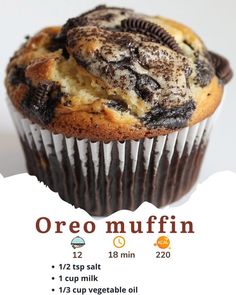 a close up of a muffin with chocolate chips on top and oreo in the middle