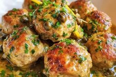 meatballs covered in sauce and garnished with parsley