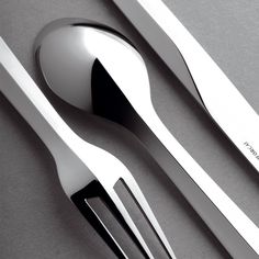 two forks, spoons and knife on a table