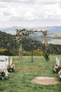 an outdoor ceremony set up with flowers and greenery