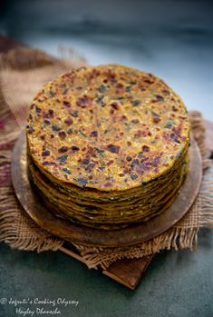 a stack of food sitting on top of a wooden plate