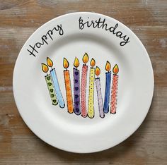 a plate with candles on it that says happy birthday