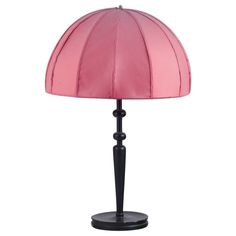 a pink table lamp on a black base