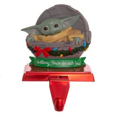 a star wars christmas ornament with a baby yoda in a bowl on top