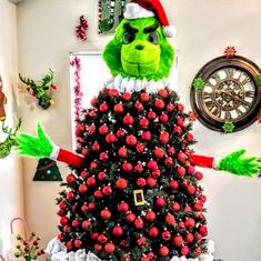 the grino tree is decorated with red and green ornaments