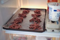 chocolate cookies are on a baking sheet in the refrigerator