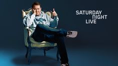 a man sitting in a chair with his thumbs up and the words saturday night live written on it