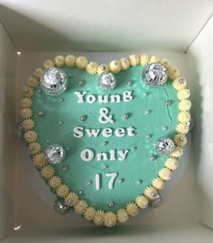 a heart shaped cake in a box that says young and sweet only 17