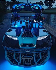 the inside of a boat with lights on it's front and back end is lit up