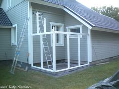 a ladder is in front of a house that has been built into the side of it