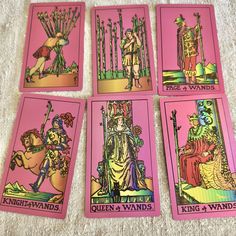 four pink tarot cards with king and queens on them, all in different colors