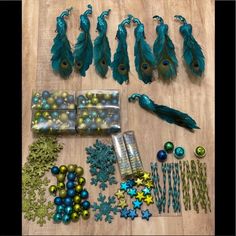 various items are displayed on a wooden surface with blue and green ornaments in the shape of peacocks