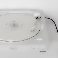 a white turntable sitting on top of a table